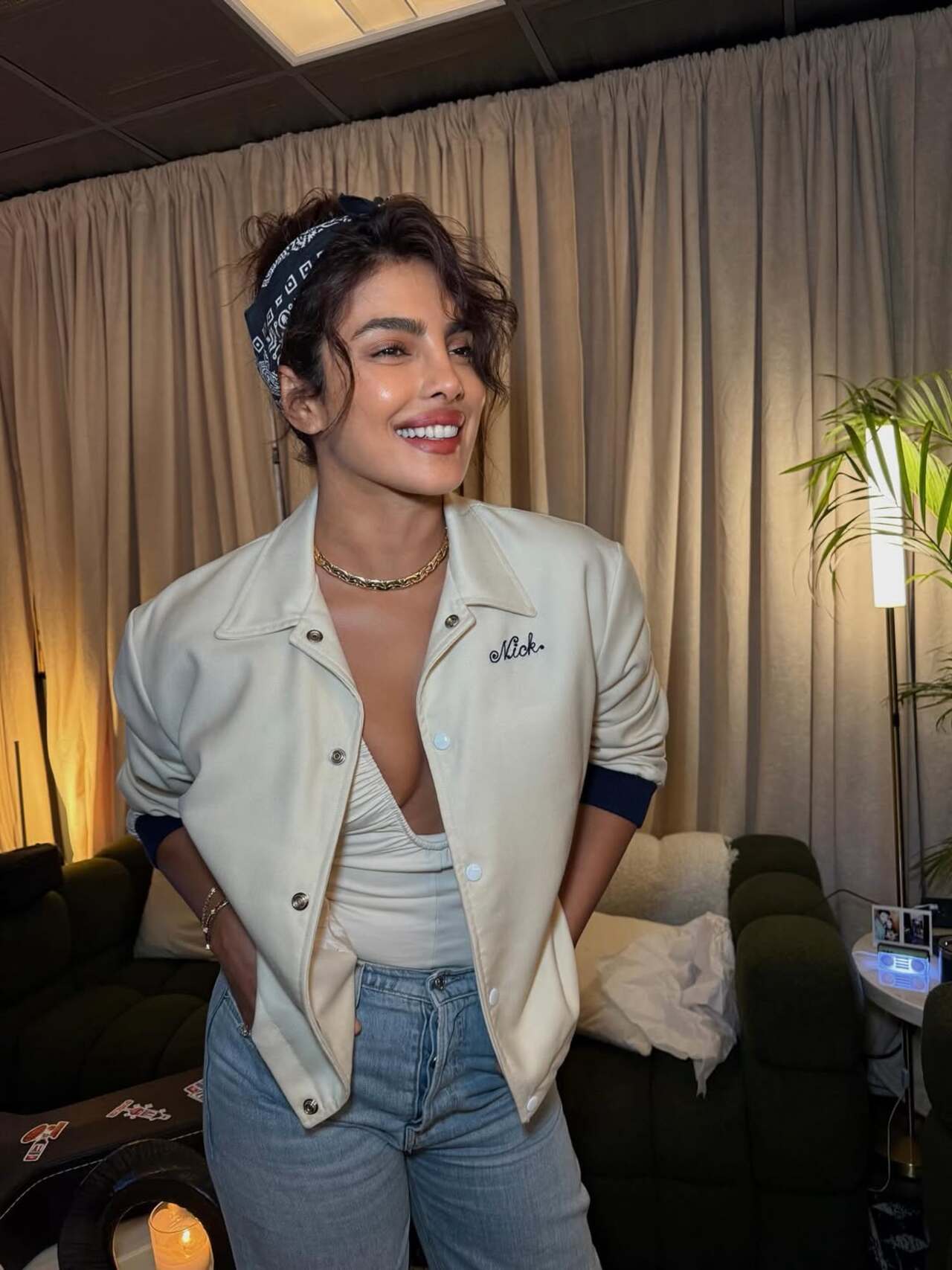 This photo captures the global star in a stylish outfit, glowing with joy as she poses for the camera. PeeCee turned cheerleader for singer by sporting a casual white jacket with Nick's name embroidered on it.